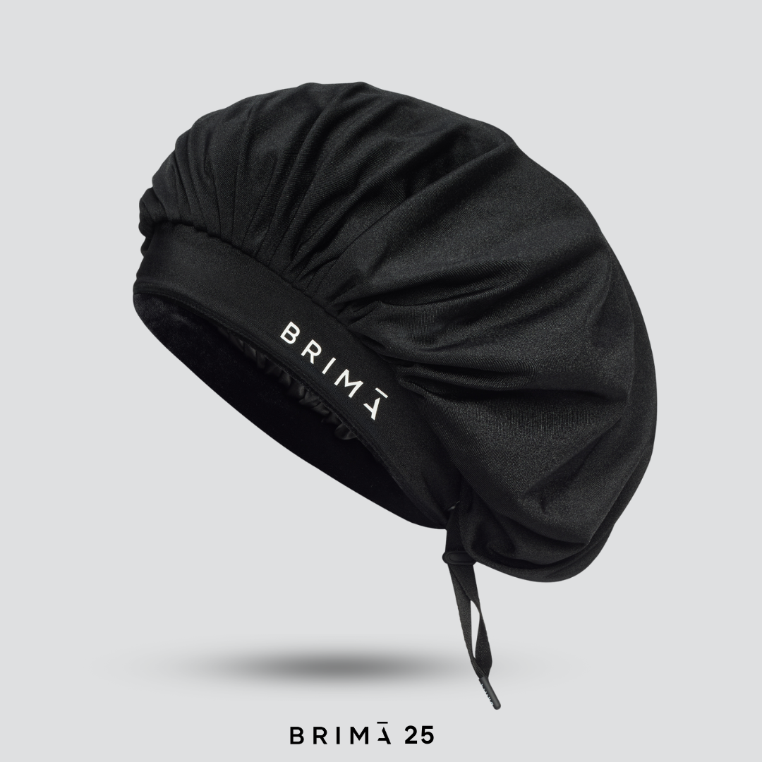 Black satin hair bonnet with 'BRIMĀ' branding on a light gray background